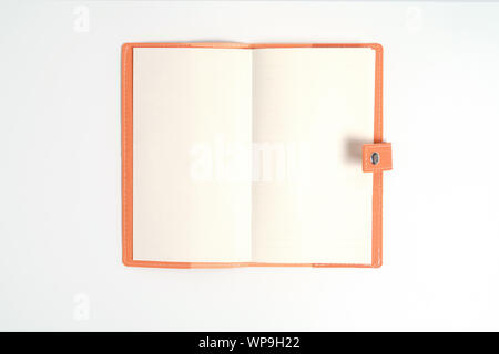 top view blank orange leather diary on white desk Stock Photo