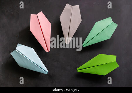 row of some color paper planes handmade origami on the tables