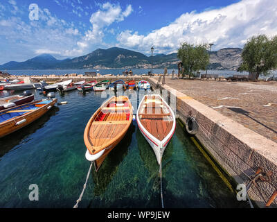 Bardolino, Italy - July 27, 2019: Fishing boats moored up in Bardolino harbour on Lake Garda Stock Photo