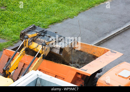 Loading construction debris into the truck for removal to the landfill Stock Photo