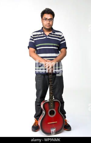 Young man holding on a guitar Stock Photo