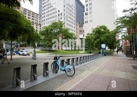 divvy bike sharing scheme docking station with almost all bikes taken at pritzker park Chicago Illinois USA Stock Photo