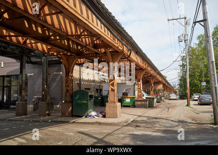 area under l train lines used for storage and garbage waste bins Chicago Illinois USA Stock Photo