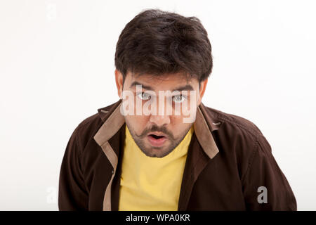 Portrait of a young man looking shocked Stock Photo