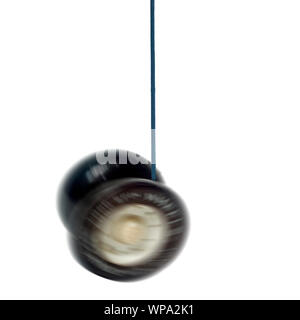 Digitally enhanced image of a spinning black and white yoyo on white background Stock Photo