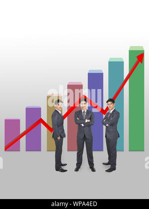 Businessman standing in front of bar graph rising upward Stock Photo
