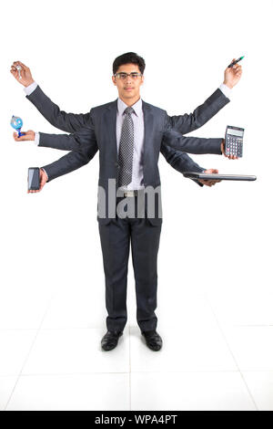 Businessman showing equipments with multiple hands Stock Photo