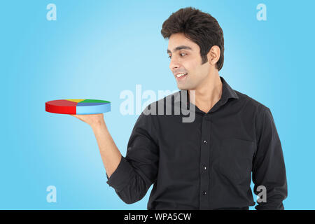 Businessman showing pie chart Stock Photo