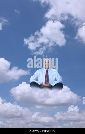 Businessman sitting on clouds practicing yoga Stock Photo