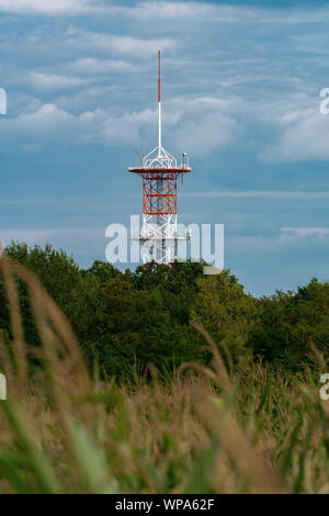 Berlin, Germany - august 17, 2019: the red and white radio tower in Berlin Frohnau sorrounded by trees Stock Photo