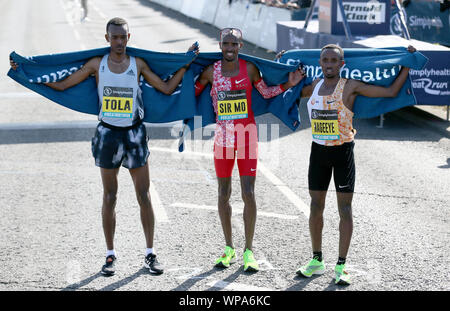 Sir Mo Farah (centre) celebrates winning the 2019 Simplyhealth Great North Run in Newcastle alongside second place Tamarit Tola (left) and third placed Abdi Nageeye. Stock Photo