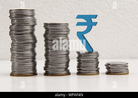 Financial crisis coins with chart going down Stock Photo