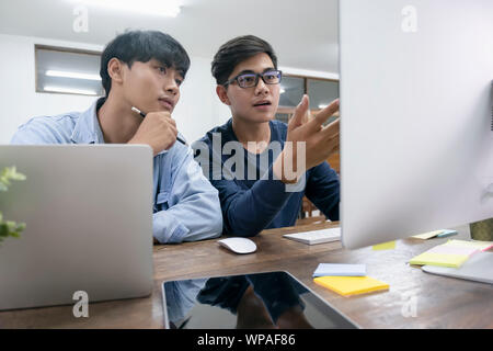 Programmers and developer teams are coding and developing software. Stock Photo
