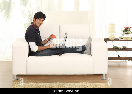 Young man doing online shopping at home Stock Photo