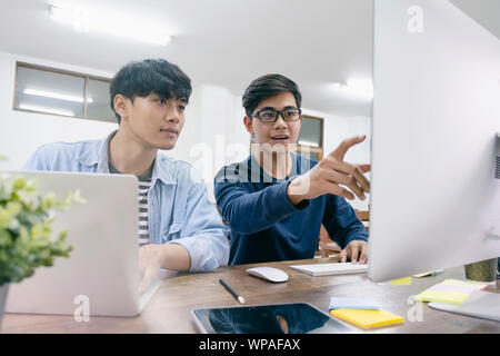 Programmers and developer teams are coding and developing software. Stock Photo