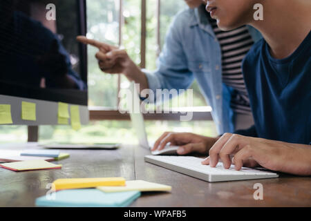 Programmers and developer teams are coding and developing software. Stock Photo