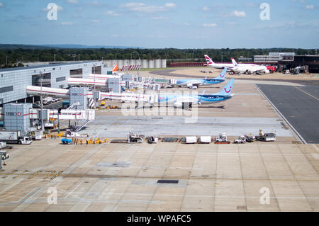 British Airways and TUI flights parked at gates in London Gatwick Airport Stock Photo