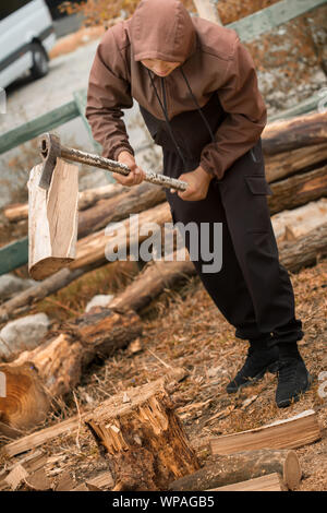 Man choping wood in the forest Stock Photo