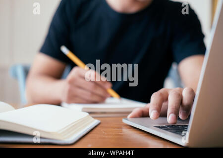 Closeup man hands using computer laptop for online learning, online business, chatting, social media. Stock Photo