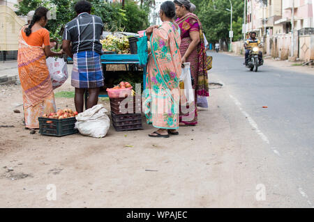 Indian women buying vegetables from a street side vendor cart Stock Photo