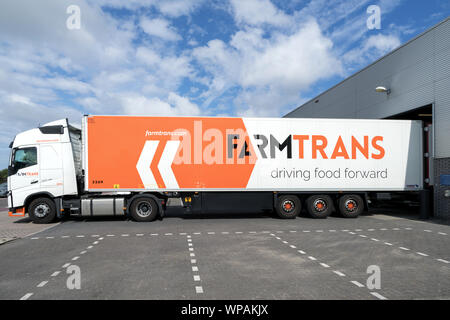 Farm Trans truck at loading dock. Farm Trans was founded in 1987 with a focus on bulk transport within the world of food transport. Stock Photo