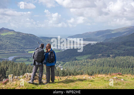 Young couple enjoying the view over the Mawddach Estuary from the Precipice Walk, , Snowdonia National Park North Wales, UK