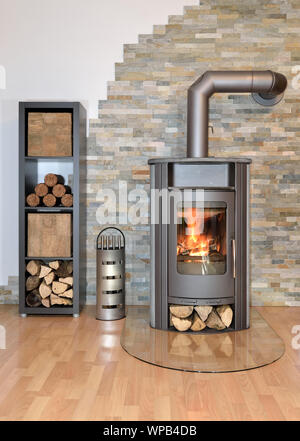 active wood burning stove in living room Stock Photo