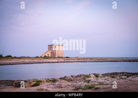 View of the ancient defensive  coastal tower Torre Lapillo at the sunset. Puglia, Italy Stock Photo