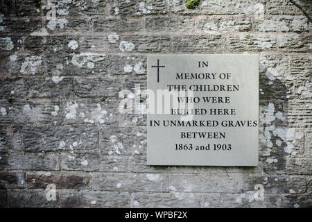 Memorial plaque in memory of children buried in unmarked graves between 1863 and 1903 at Belmont Abbey Hereford UK Stock Photo