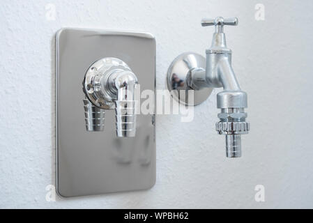 Water tap with hose connection for dish washer or washing machine Stock Photo