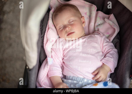 Baby sleeping in a baby carriage in the air. Stock Photo