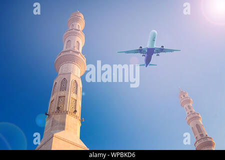 Plane in the sky over mosque. Holiday and travel concept