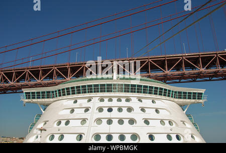 Lisbon, Portugal - September 2011: The cruise liner Independence of the Seas passing under the 25 de Abril suspension bridge in Lisbon Stock Photo