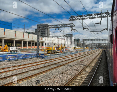 LONDON, ENGLAND - JUNE 2018: View from a train of new gantries and overhead cabling for the electrification of the main line west of London Stock Photo