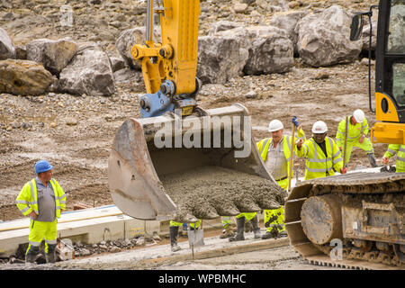 PORTHCAWL, WALES - JUNE 2018: Construction operatives working on the redevelopment of the seafront in the centre of the promenade in Porthcawl Stock Photo