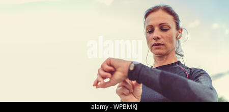 Woman monitoring her progress on smart watch Stock Photo