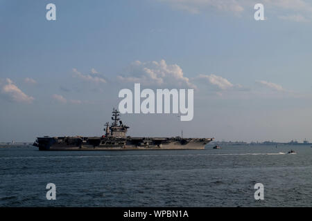 NORFOLK (Sept. 7, 2019) The Nimitz-class aircraft carrier USS Dwight D. Eisenhower (CVN 69) returns to its homeport of Norfolk, Va. after being sent to sea to avoid the effects of Hurricane Dorian. Hampton Roads area ships are returning to their homeport now that the threat from Hurricane Dorian has passed. (U.S. Navy photo by Mass Communication Specialist 1st Class Joshua D. Sheppard/Released) Stock Photo