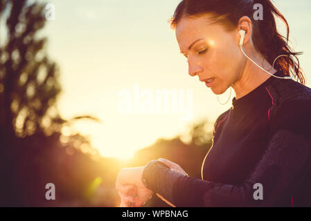 Woman monitoring her progress on smart watch Stock Photo