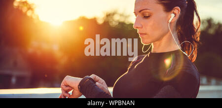 Woman monitoring her progress on smart watch Stock Photo