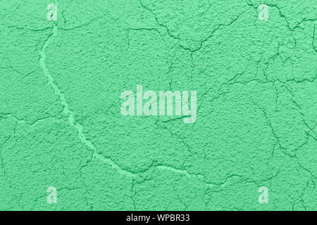 Textured background yellow clay cracked plaster. Wall background. Wall plastering Stock Photo