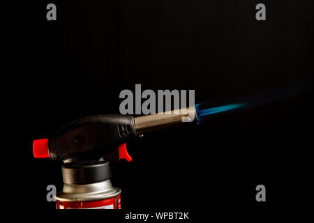Flame gas burner dark background DIY tools with blue flame Stock Photo