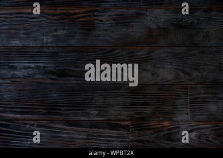 BBQ background. Burnt wooden Board texture. Burned scratched hardwood surface. Smoking wood plank background. Burned wooden grunge texture Stock Photo
