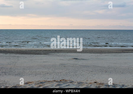 Classical beach view of the North Sea with its tidal movement during sunset Stock Photo