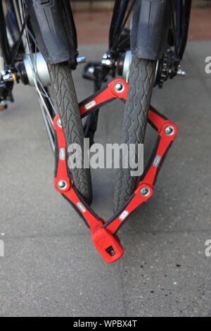 Heavy foldable anti-theft bike lock. Two bicycles locked together. Photo by Willy Matheisl Stock Photo
