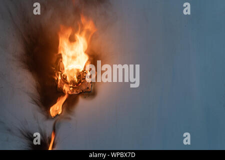 Apartment fire is caused by electrical outlet faults. Burnt and damaged electric plug socket from overload short circuit. Stock Photo