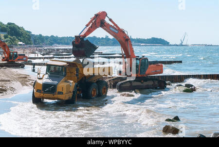 construction equipment on the seashore, construction of breakwaters in the Baltic sea, Baltic sea, Kaliningrad region, Russia, July 15, 2018 Stock Photo
