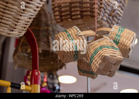 Decorative knitted baskets. Hanging from above. The photo was taken in front of the store. Stock Photo