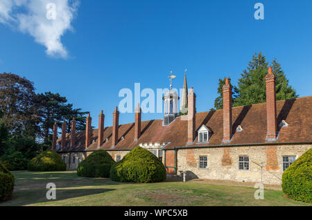 Rear of Long Alley Almshouses with roof lantern and spire of St Helen's Church, Abingdon-on-Thames, Oxfordshire, south-east England, UK Stock Photo
