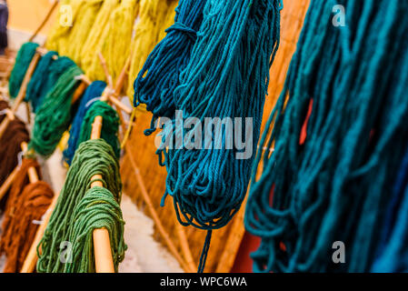 Yarns of colored wool freshly dyed by Arab craftsmen drying in the sun. Stock Photo