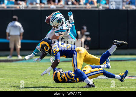 Los Angeles Rams safety Jason Taylor II, right, runs a play